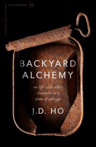 Book cover with black background with rusted sardine can with title Backyard Alchemy in white text